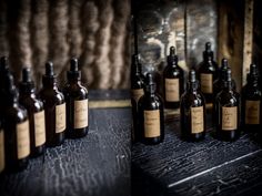 several bottles are lined up on a table with brown paper labels in front of them