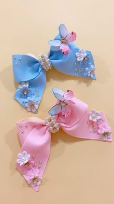 three bows with flowers and pearls on them