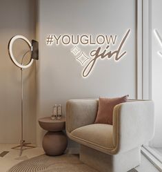 a room with a chair, table and lamp on the wall that says youglow girl