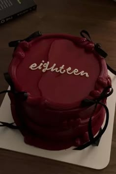 a red cake with the word eighteen written on it