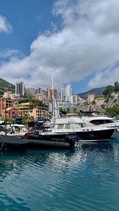 several boats are docked in the water near some buildings