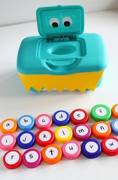 a plastic toy with letters and numbers on it next to a set of magnets