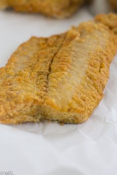 fried fish fillets are sitting on wax paper