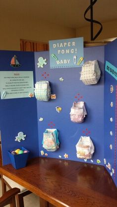 a baby shower with diapers on the wall and other items attached to the walls