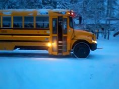 a school bus is parked in the snow with its door open and it's lights on