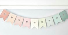 a paper banner with hearts hanging from it