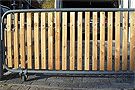 a metal gate with wooden slats on it