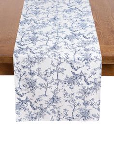 an image of a table with a blue and white floral design on it, along with a wooden table top