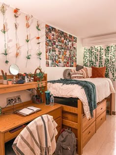 a bed room with a neatly made bed next to a wooden desk and dressers