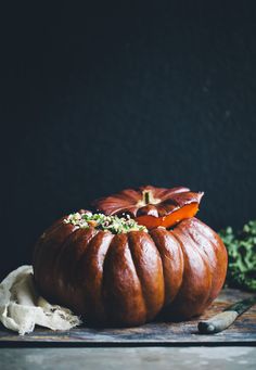 a pumpkin sitting on top of a wooden table