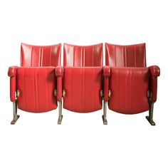 three red leather chairs sitting next to each other