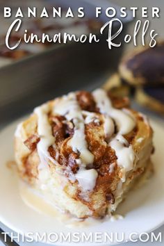 banana fosterer cinnamon rolls on a white plate