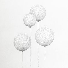 three white balloons are floating in the air with string attached to it's sides