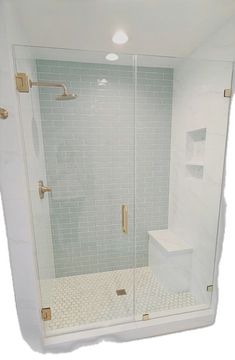 a walk in shower sitting next to a white tiled wall and floor with gold fixtures