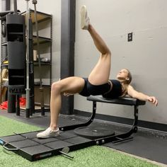 a woman doing exercises on a bench in a gym