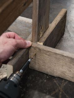 a person is working on some wood with a drill