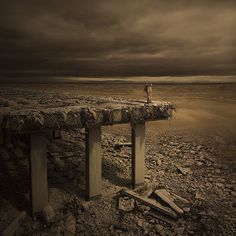 a person standing on top of a bench in the middle of nowhere