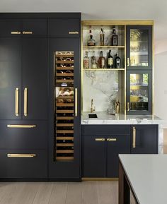 a kitchen filled with lots of counter top space next to a wine rack and cabinets