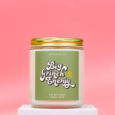 a candle with the words big crunch and energy on it sitting on top of a white block