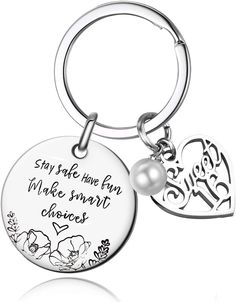 a keychain with a heart and flower design on it, that says stay safe have fun make smart choices