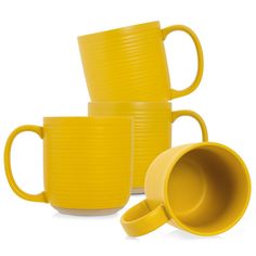 three yellow mugs stacked on top of each other with their lids open and one cup in the middle