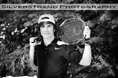 a young man holding a tennis racquet on top of a tennis ball court