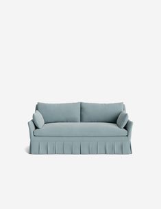 a blue couch sitting on top of a white floor