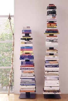 a tall stack of books sitting on top of a wooden floor