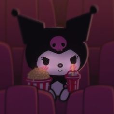 a cartoon character holding a cup with popcorn and a candle in it's mouth