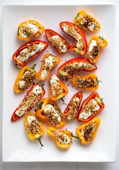 stuffed bell peppers with cheese and herbs on a white surface