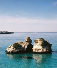 two large rocks sticking out of the water