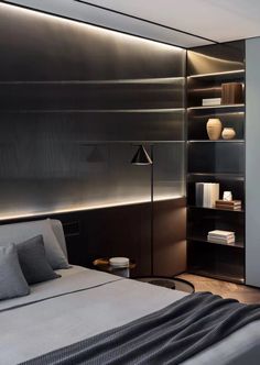 a modern bedroom with black and white decor, built - in shelvings and shelves