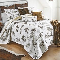 the bed is made up and has many pillows on it, including one with an animal print