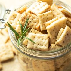 a glass jar filled with crackers and herbs