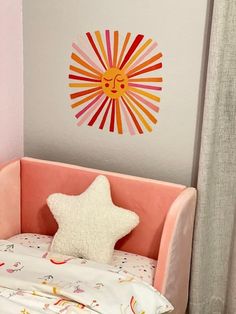 a small child's bed with a star pillow on it