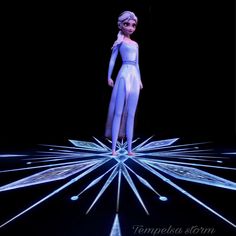 a barbie doll is standing in the middle of a star with lights on it's sides