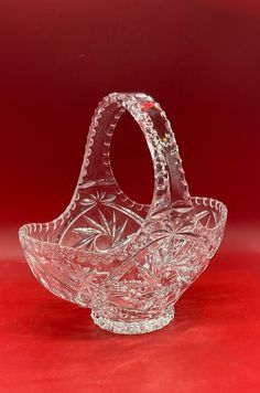 a glass basket sitting on top of a red table