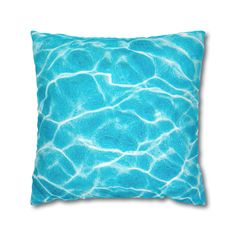 a blue pillow with water ripples on it