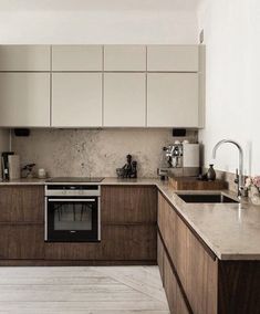 a kitchen with an oven, sink and counter tops in it's center island