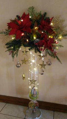 a vase filled with christmas decorations and lights