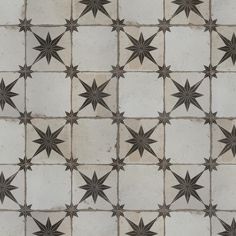 an artistic tile pattern with stars on it