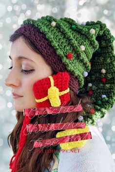 a woman wearing a crocheted christmas hat and scarf with bells on her head