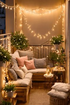 a balcony decorated with lights and potted plants