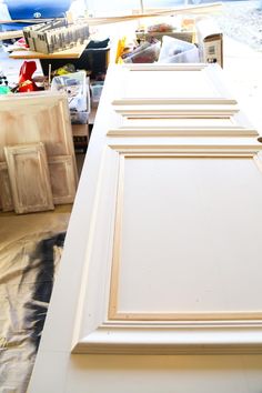 an unfinished cabinet door is being painted white