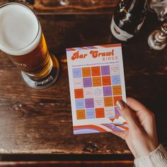 a person holding up a beer next to a pint of beer and a menu