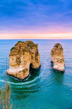 two large rocks sticking out of the ocean