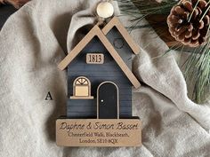 a house shaped ornament with a name on it