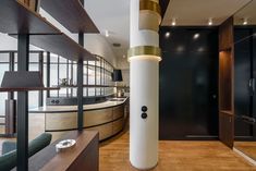 a large white column sitting in the middle of a living room next to a wooden floor