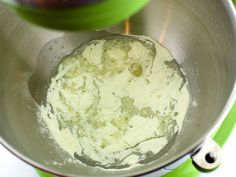 a metal bowl filled with food on top of a green stovetop oven burner