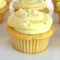 cupcakes with white frosting and sprinkles on them